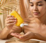 woman pouring hair oil yellow bottle