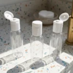 50ml transparent bottle with white flip top cap on a terrazzo vanity counter